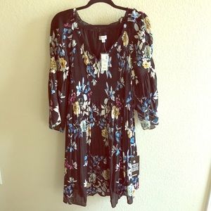 Navy floral dress with bell sleeves.